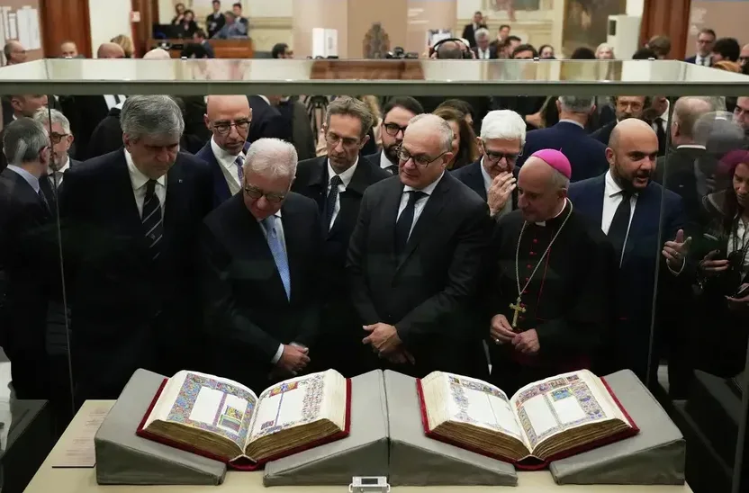 Visitors looking at the bibles in a glass display case