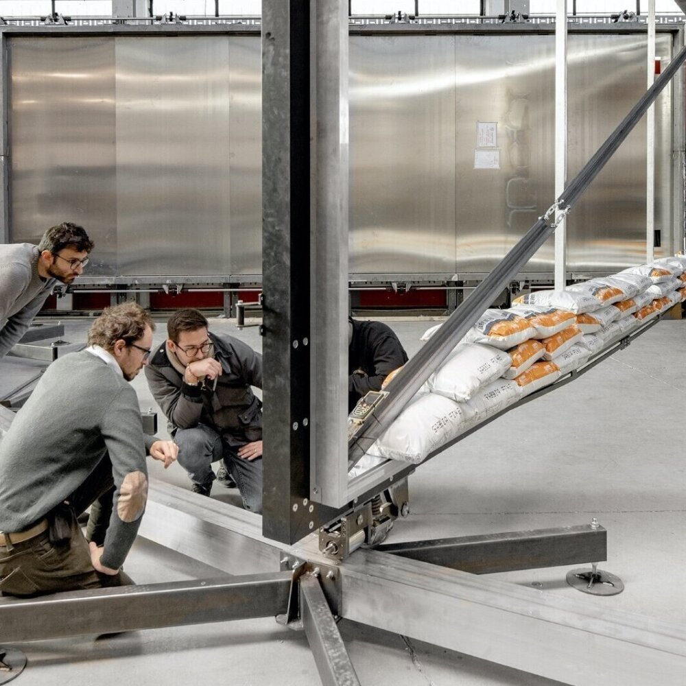 Goppion workers examine a prototype component for a museum display case